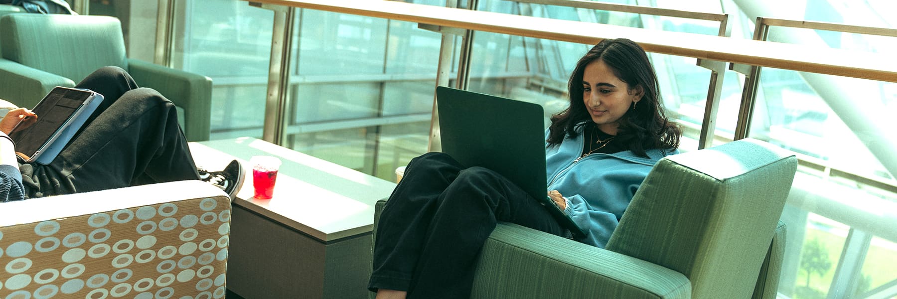 student studies in ISC in a lounge chair.